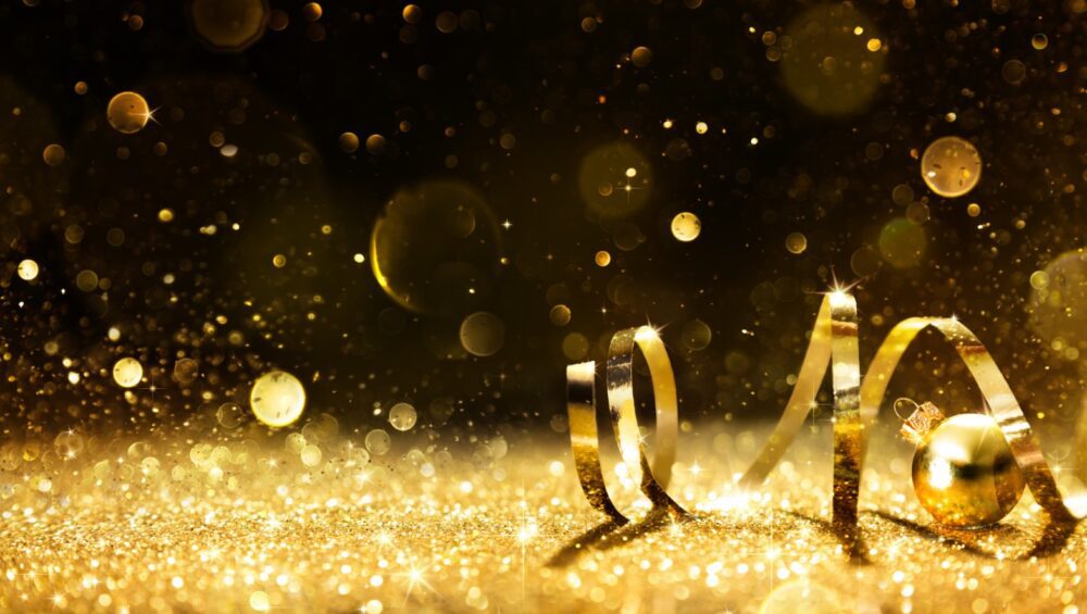 Golden ribbon on shining gold glitter