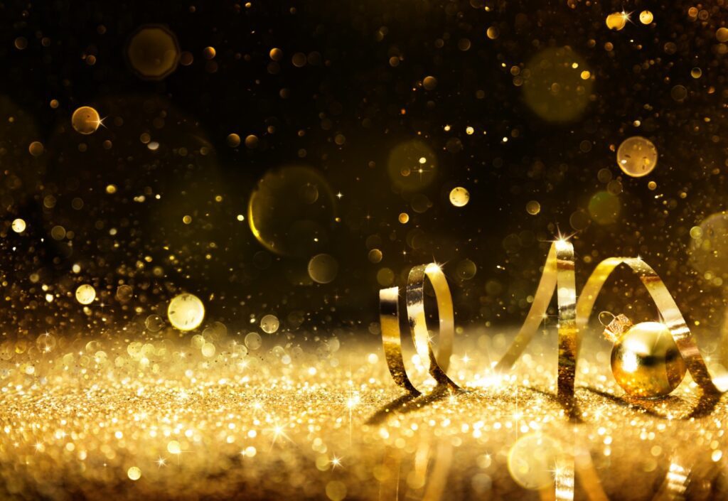 Golden ribbon on shining gold glitter
