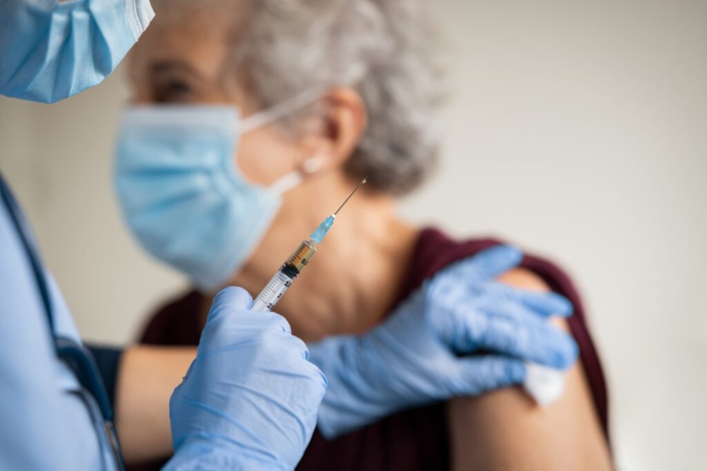 Elderly woman receiving flu shot