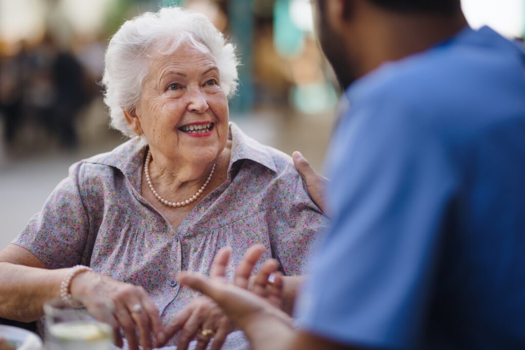 Caregiver talking to elderly woman