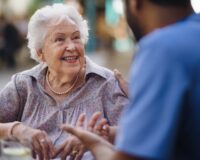 Caregiver talking to elderly woman