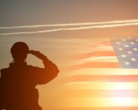 Soldier saluting American flag