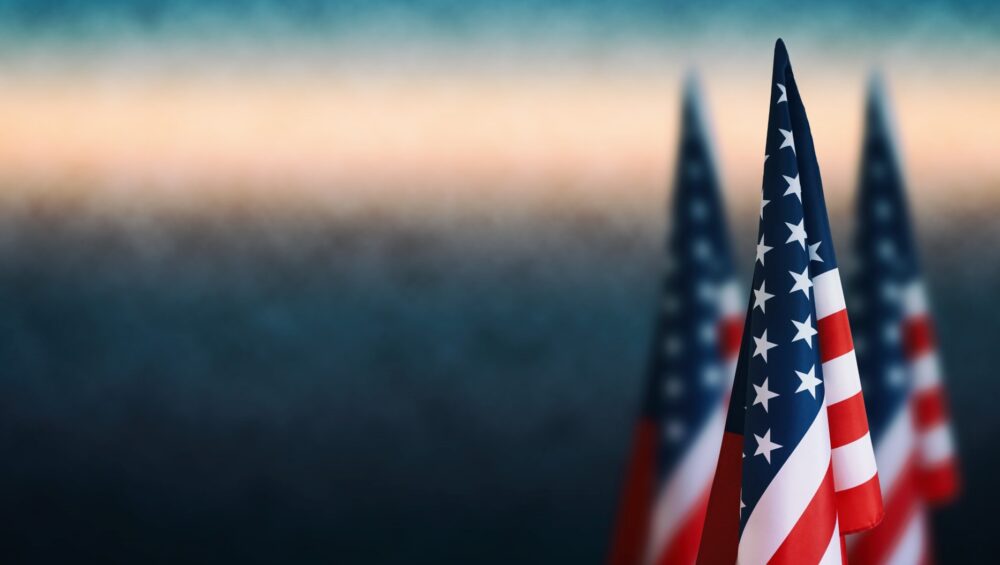 Three American flags on the right side of a background image