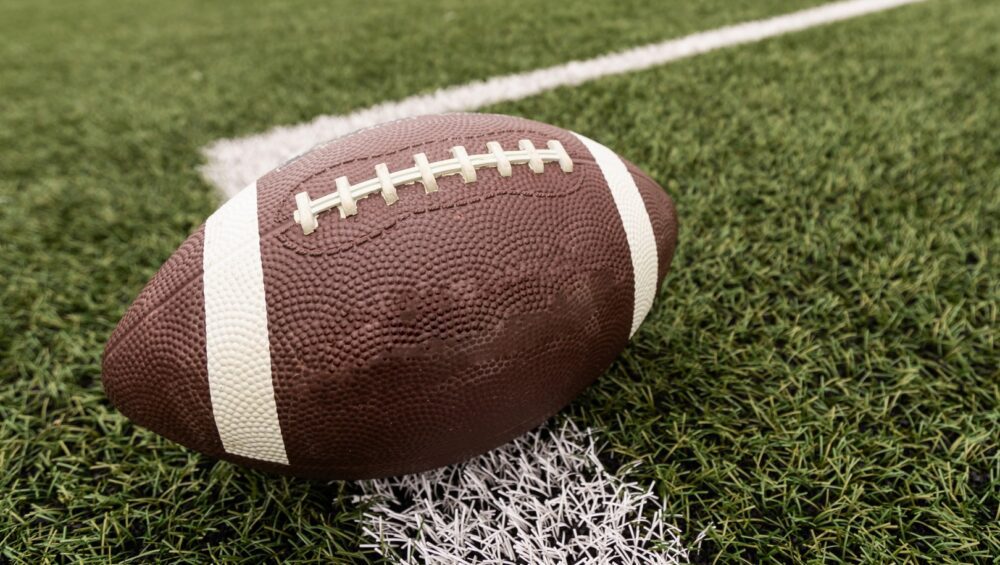 An isolated football close-up on a football field.