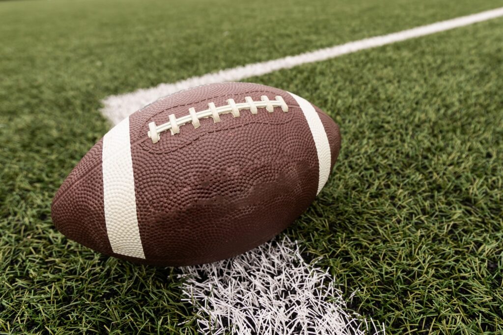 An isolated football close-up on a football field.