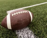 An isolated football close-up on a football field.