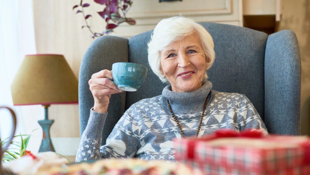 Happy Senior Lady Enjoying Winter Tea