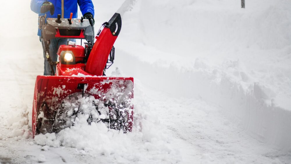 Man clearing or removing snow with a snowblower