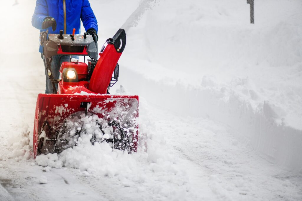 Man clearing or removing snow with a snowblower