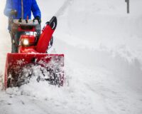 Man clearing or removing snow with a snowblower