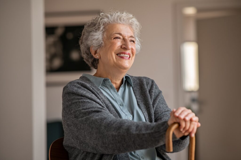 Happy smiling senior woman with cane.