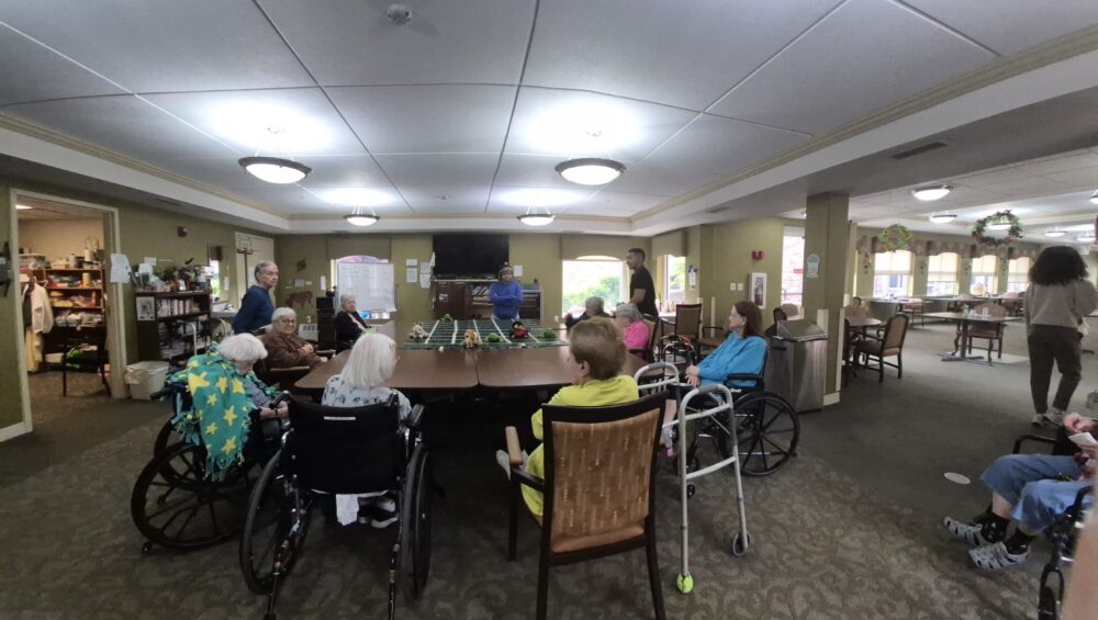 Residents of Manoogian Manor playing games around a large table.