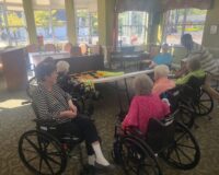 Manoogian Manor residents playing skee ball game