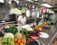 Manoogian Manor kitchen full of fresh vegetables and cooks.