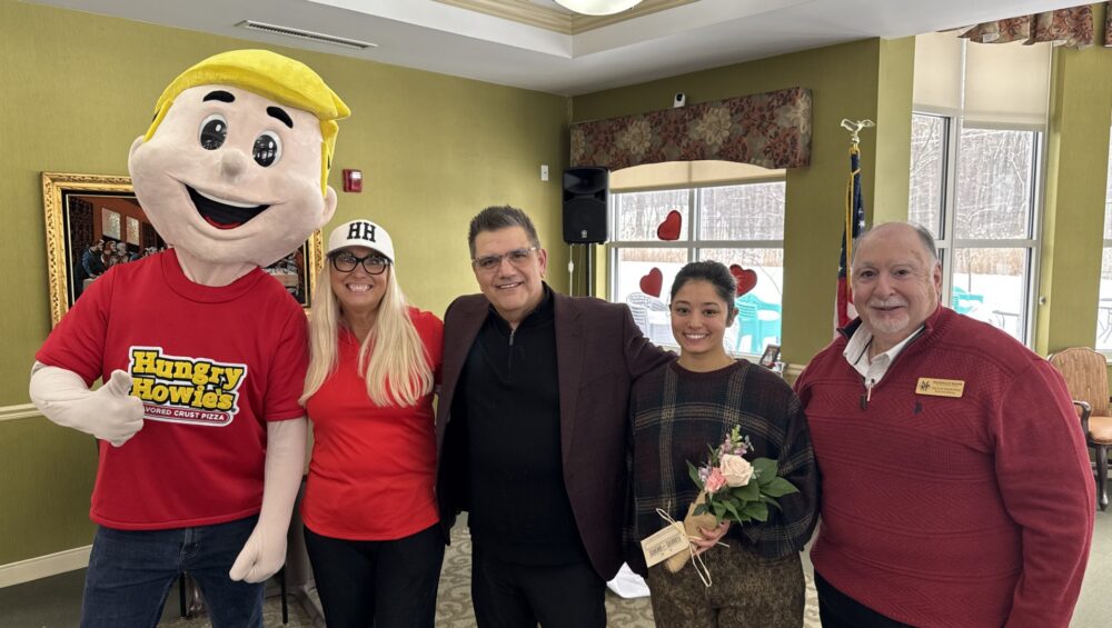 Hungry Howie's mascot Howie and Jennifer Jackson, a representative of Flowers for Dreams, along with Robert Harrison and Vaughn Masropian of Manoogian Manor.