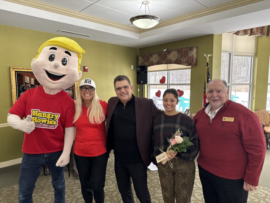 Hungry Howie's mascot Howie and Jennifer Jackson, a representative of Flowers for Dreams, along with Robert Harrison and Vaughn Masropian of Manoogian Manor.