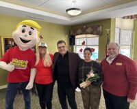 Hungry Howie's mascot Howie and Jennifer Jackson, a representative of Flowers for Dreams, along with Robert Harrison and Vaughn Masropian of Manoogian Manor.